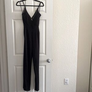 Black jumpsuit. Size small. Never worn. Black lace back with lower back cutout.